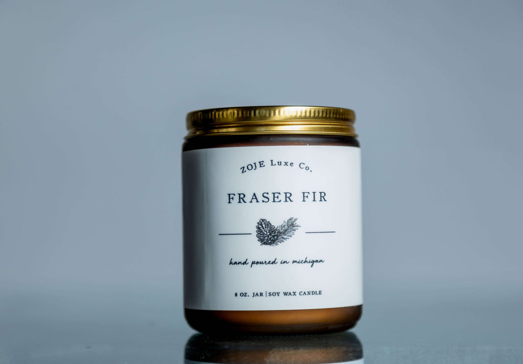 Our Fraser Fir candles begins with top notes of cypress and zesty lemon peel that fold into woodsy mid notes of evergreen and cedar. The rich base of fir, amber, and moss evokes fond memories of decorating a freshly-cut Christmas tree. Fraser Fir is perfect for setting a festive holiday mood or creating a cozy ambience for a quiet winter evening by the fire.